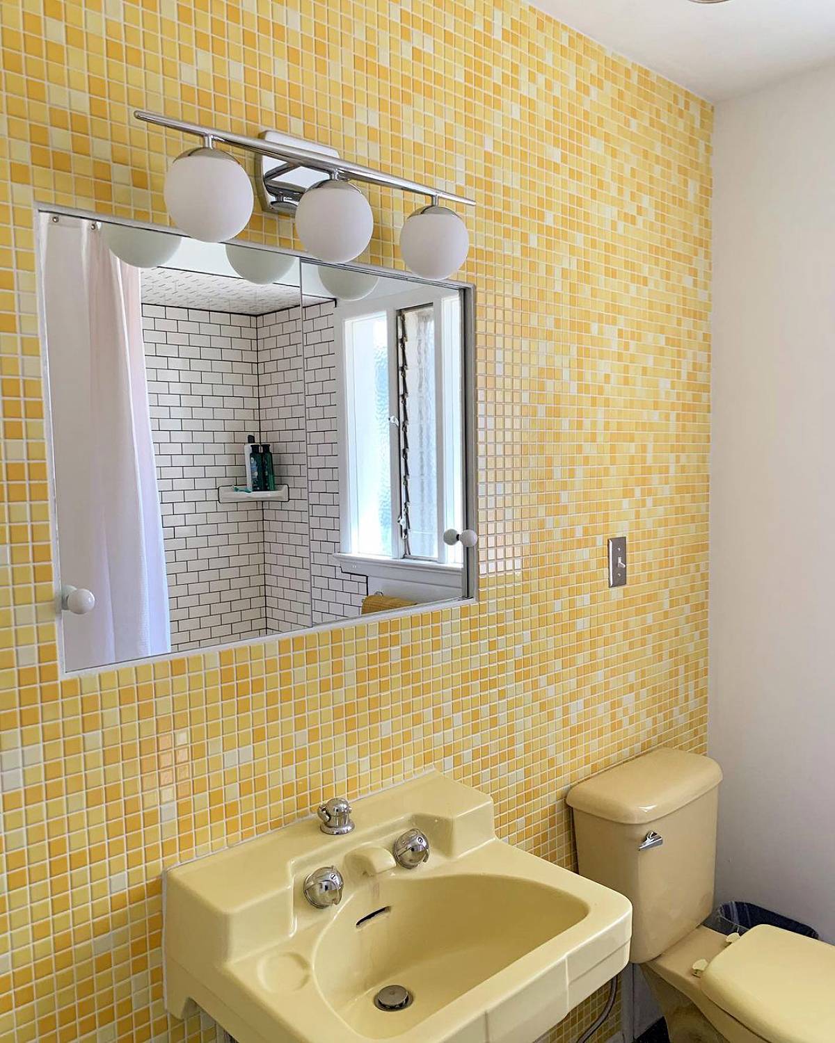 Yellow bathroom with small mediterranean wall tiles