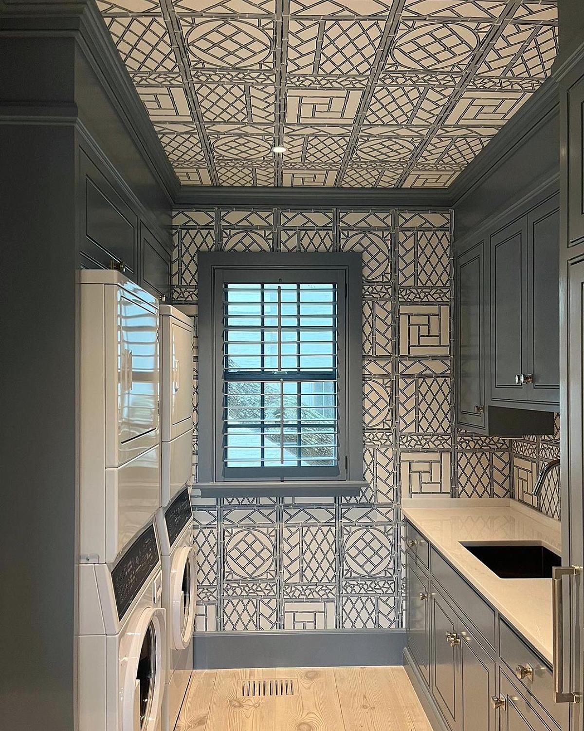 laundry room with geometric wallpaper