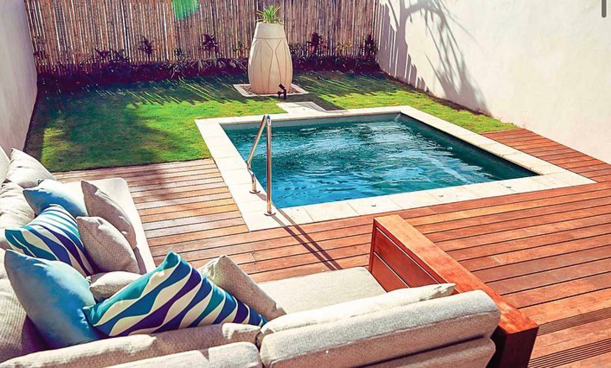 pool with grass and wooden deck