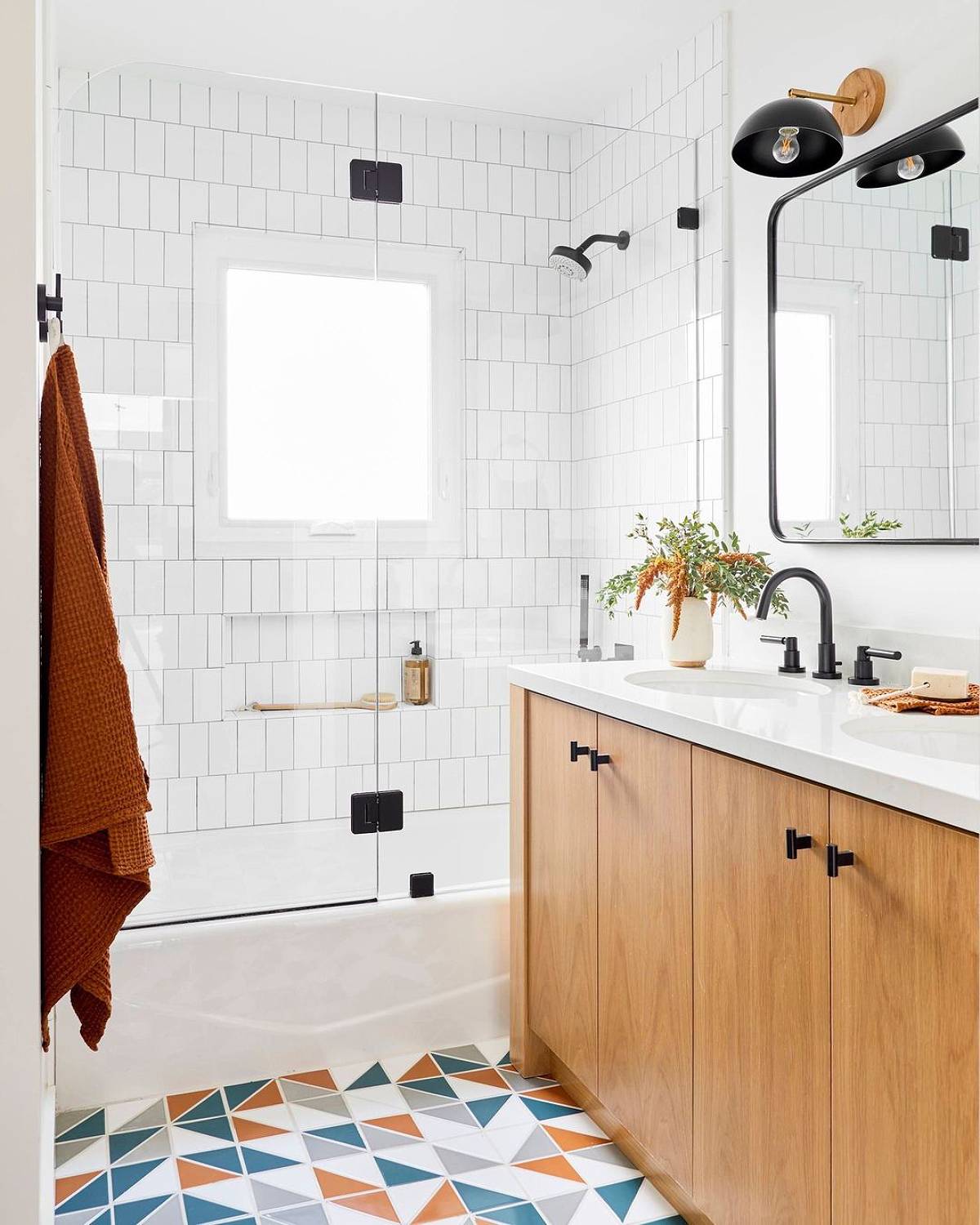 white bathroom with colorful floor tiles