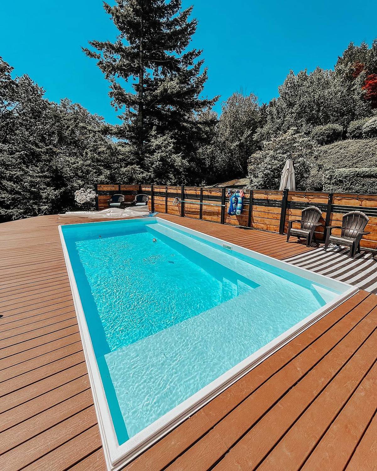 white pool with wooden deck