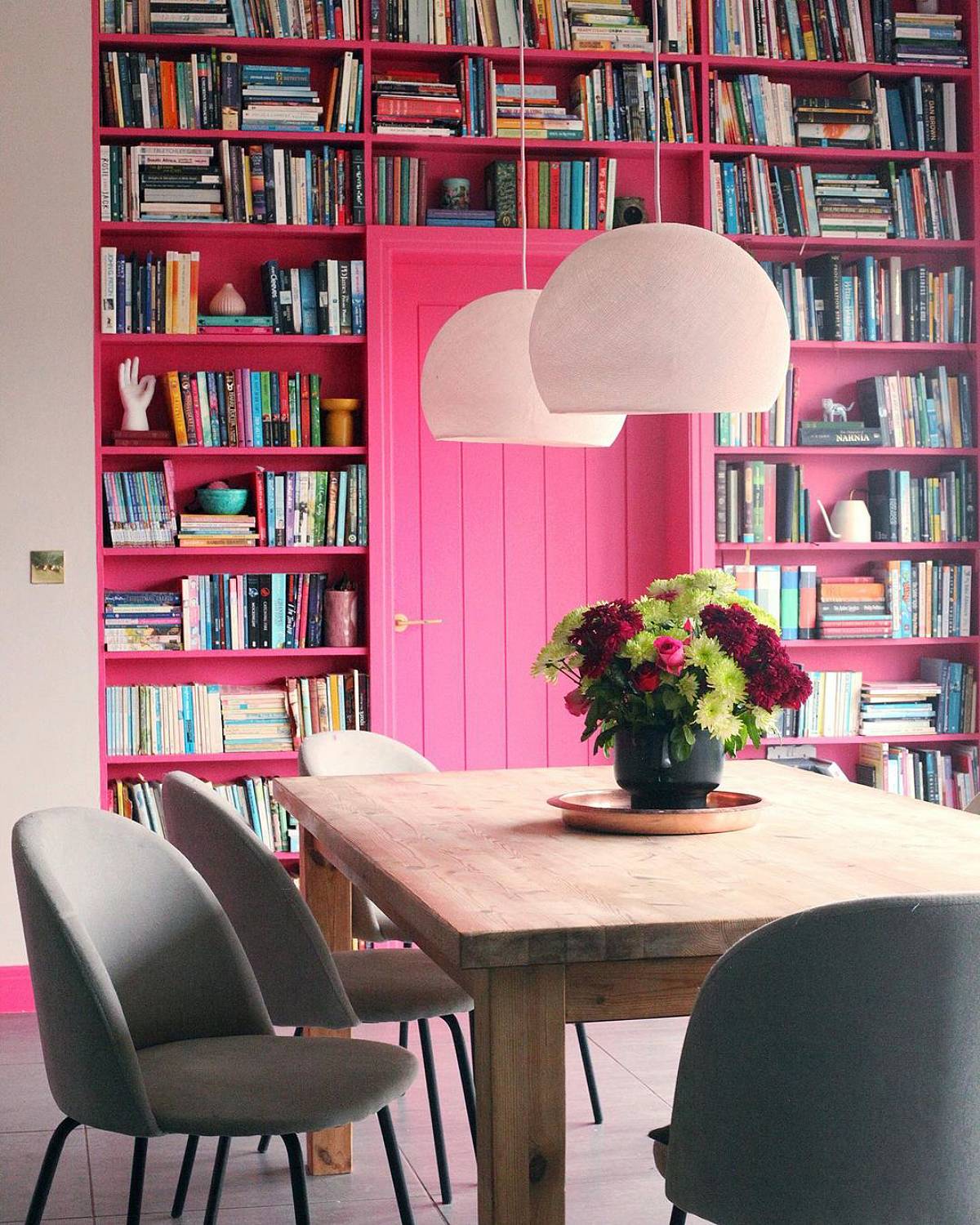 pink bookshelves around the pink door